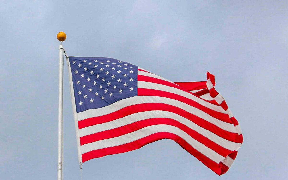 The American flag close up against a cloudy sky
